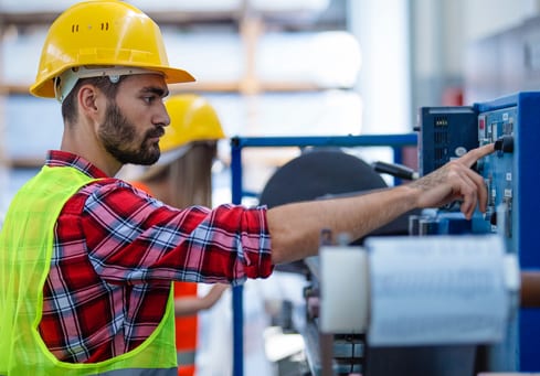 worker pressing a button